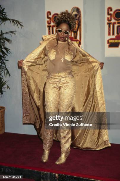 American singer and songwriter Mary J Blige, wearing a gold outfit with a gold coat, in the press room of the 11th Soul Train Music Awards, held at...