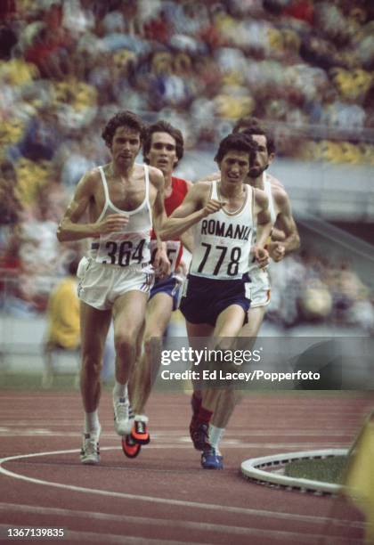 Ilie Floroiu of Romania leads Brendan Foster of Great Britain to qualify in 4th place and 2nd place respectively in heat 2 of the Men's 10,000 metres...