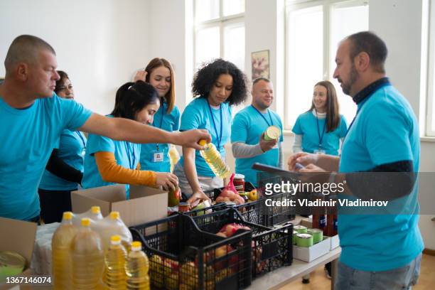 group of people working in charitable foundation - liefdadigheidsinstelling stockfoto's en -beelden
