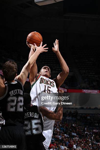 Tobias Harris of the Milwaukee Bucks goes to the basket against Tiago Splitter and James Anderson of the San Antonio Spurs during the fourth quarter...