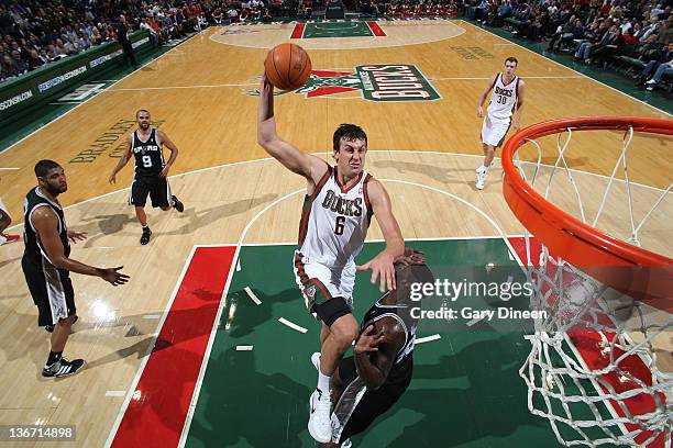 Andrew Bogut of the Milwaukee Bucks goes to the basket against DeJuan Blair of the San Antonio Spurs during the game on January 10, 2012 at the...