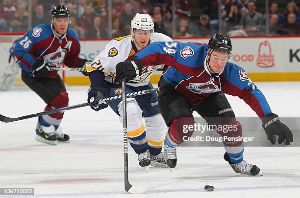 Galiardi of the Colorado Avalanche looks to collect the puck as Matt Halischuk of the Nashville Predators and Paul Stastny of the Colorado Avalanche...