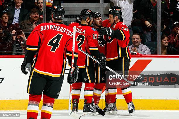 Curtis Glencross, Jarome Iginla, Olli Jokinen and Jay Bouwmeester of the Calgary Flames celebrate a goal against the New Jersey Devils on January 10,...