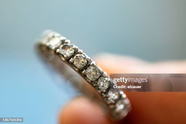 a wedding ring made of platinum and diamonds - metal fingers stock pictures, royalty-free photos & images