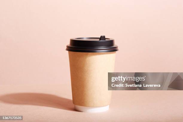 front view of eco friendly paper craft cup for coffee with black lid on the beige background. zero waste, plastic free concept. sustainable lifestyle. front view. - disposable cup bildbanksfoton och bilder