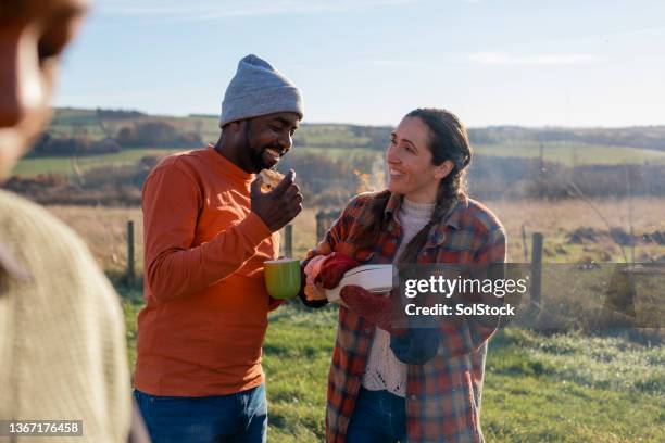 couple enjoying packed lunch outdoors together - couple farm stock pictures, royalty-free photos & images