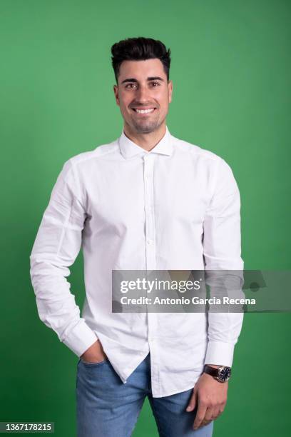 happy handsome man portrait on green background smiling - chroma key fotografías e imágenes de stock