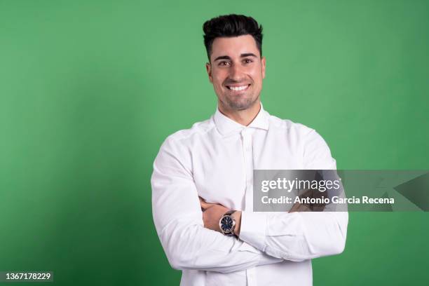 happy handsome man portrait on green background smiling - grünes hemd stock-fotos und bilder