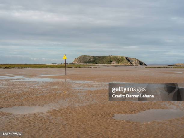 the headland of brean down & warning sign - quicksand sign stock pictures, royalty-free photos & images