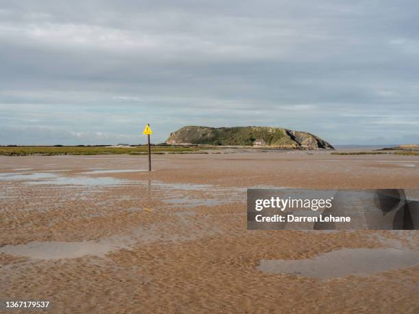 the headland of brean down & warning sign - quicksand stock pictures, royalty-free photos & images