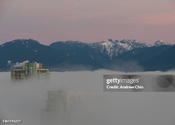 Buildings are seen amid fog in Metro Vancouver on January 27, 2022 in Vancouver, British Columbia, Canada.