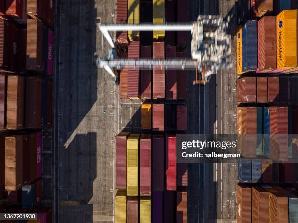 top down aerial shot of straddle carrier in intermodal container terminal - port of long beach stock pictures, royalty-free photos & images