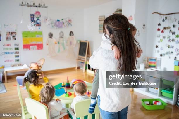 kindergarten teacher at school - kinderopvang stockfoto's en -beelden