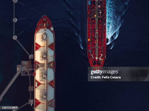 aerial view of a liquified natural gas tanker and a crude oil tanker. - scheepvaart stockfoto's en -beelden