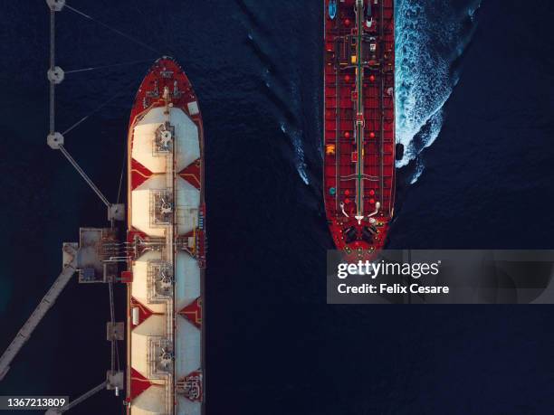 aerial view of a liquified natural gas tanker and a crude oil tanker. - oil industry stock pictures, royalty-free photos & images