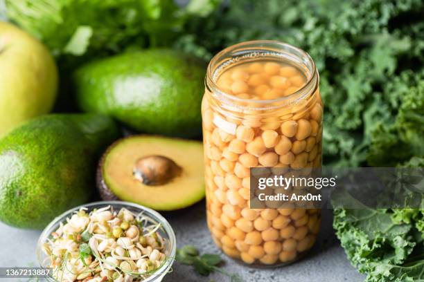 canned chickpeas in brine and green vegetables - legume stock pictures, royalty-free photos & images