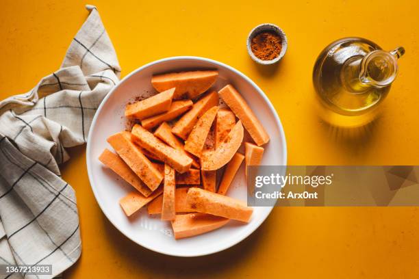 sweet potato wedges before oven - baked sweet potato stock-fotos und bilder