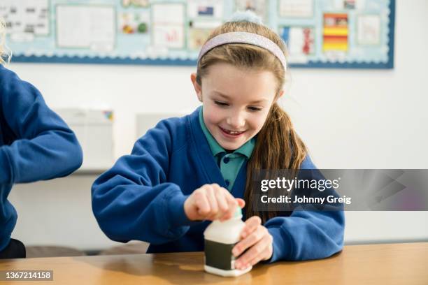 primary school child opening milk container during break - open day 7 stock pictures, royalty-free photos & images