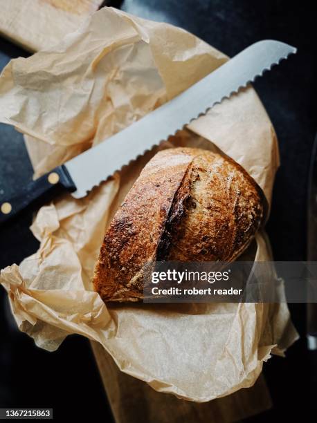 homemade sourdough bread - bread knife stock-fotos und bilder