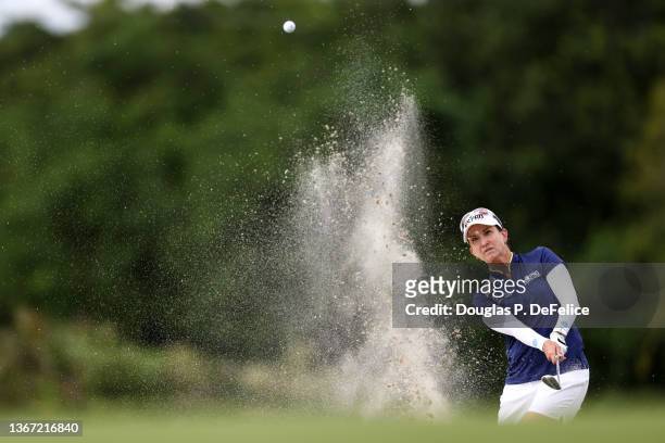 Karrie Webb chips the ball from the bunker on the 18th hole during the first round of the 2022 Gainbridge LPGA at Boca Rio Golf Club on January 27,...