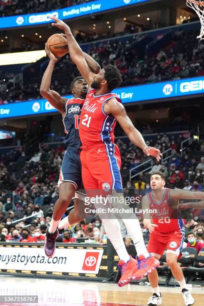 Joel Embiid of the Philadelphia 76ers tries to block Thomas Bryant of the Washington Wizards shot during a NBA basketball game at the Capital One...