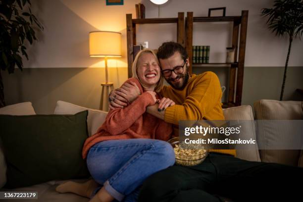 couple watching tv and eating popcorn - couple tv bildbanksfoton och bilder