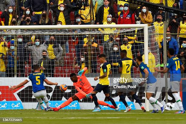 Casemiro of Brazil scores the first goal of his team against Alexander Domínguez goalkeeper of Ecuador during a match between Ecuador and Brazil as...