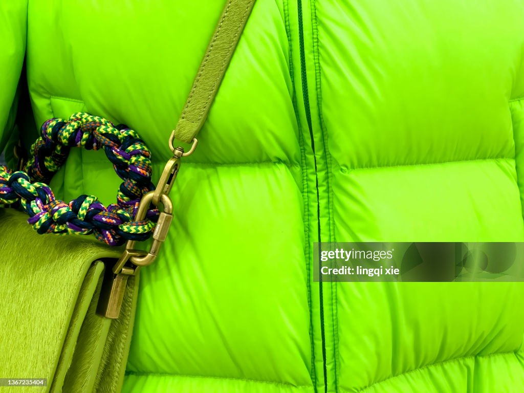 Green down jacket with green shoulder bag