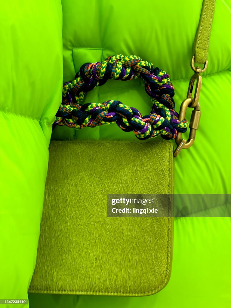 Green down jacket with green shoulder bag