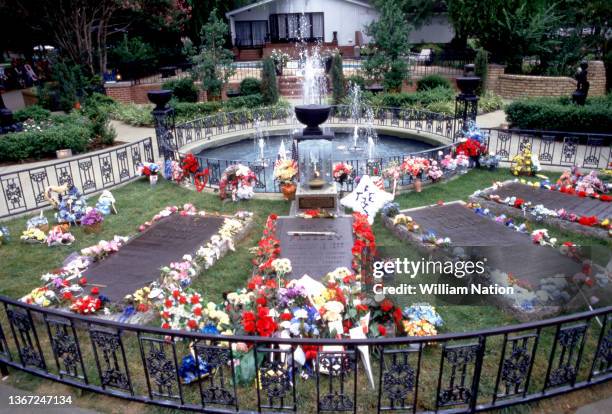 The headstones for Minnie Mae Presley, Elvis Aaron Presley, Vernon Elvis Presley and Gladys Love Smith Presley are surrounded with flowers, gifts,...