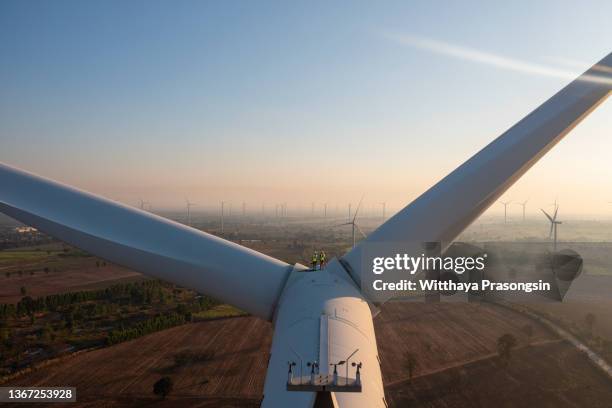 three wind turbines at sunrise - klinge stock-fotos und bilder