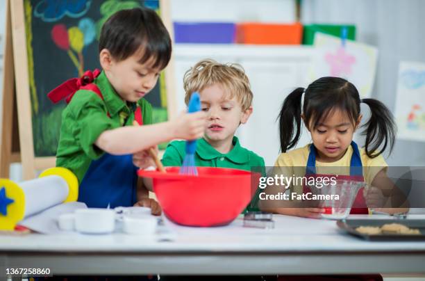 preschool children baking - children cooking school stock pictures, royalty-free photos & images