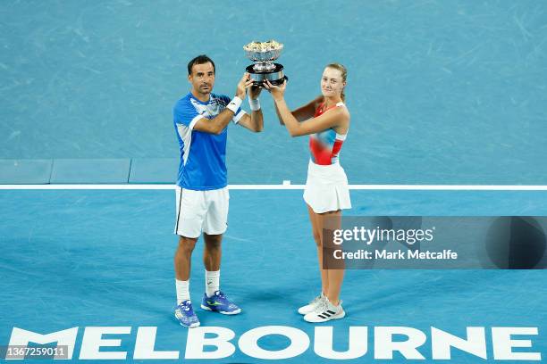 Ivan Dodig of Croatia and Kristina Mladenovic of France pose with the champions trophy after winning the Mixed Doubles Final against Jaimee Fourlis...