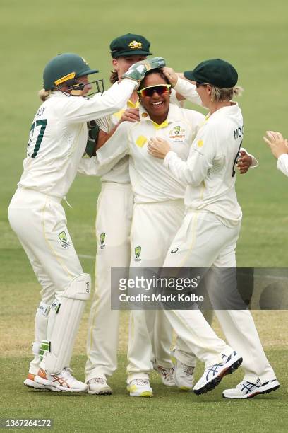 Alana King of Australia celebrates with her team after taking the wicket of Katherine Brunt of England during day two of the Women's Test match in...