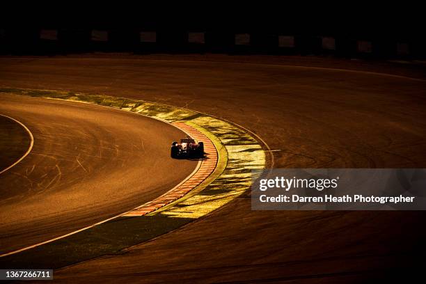 Photographed in silhouette, back lit, sunset light, Brazilian Scuderia Ferrari Formula One team racing driver Felipe Massa driving his F138 racing...