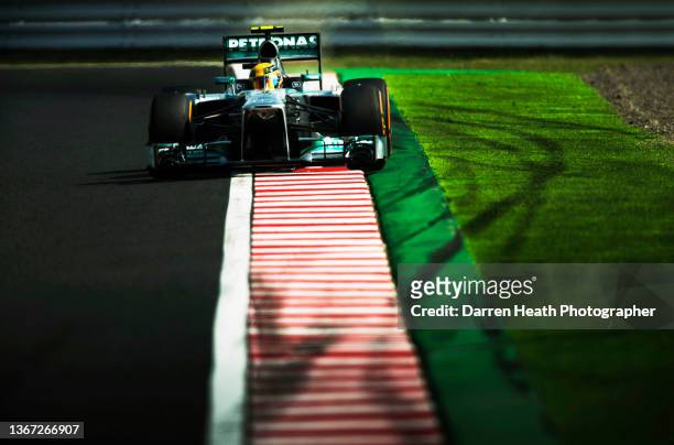 British Mercedes-AMG Formula One team racing driver Lewis Hamilton driving his F1 W04 racing car at speed over the corner exit kerb and on to the...