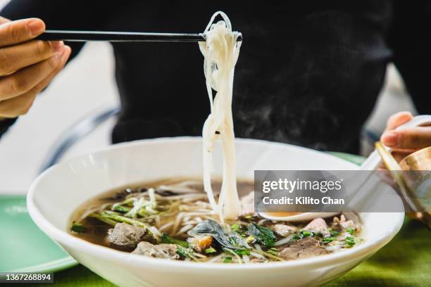 enjoying southeast asian food -vietnam pho, green curry beef and fried water spinach - pho stock pictures, royalty-free photos & images