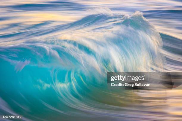 a single slow shutter photograph of a wave - fast shutter speed foto e immagini stock