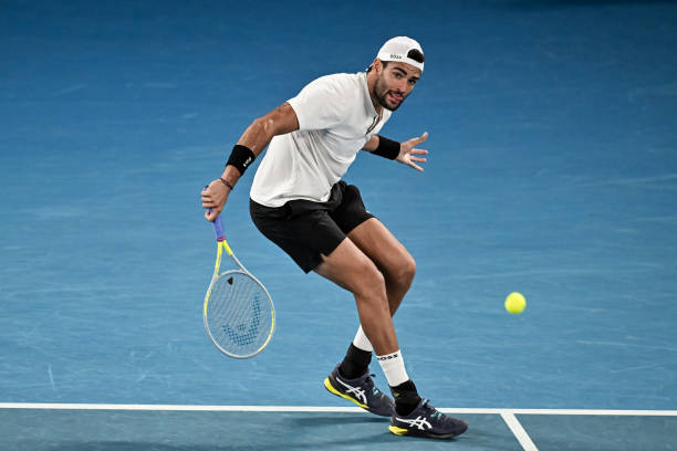 Matteo Berrettini of Italy hits a backhand against Rafa Nadal of Spain during day 12 of the 2022 Australian Open at Melbourne Park on January 28,...