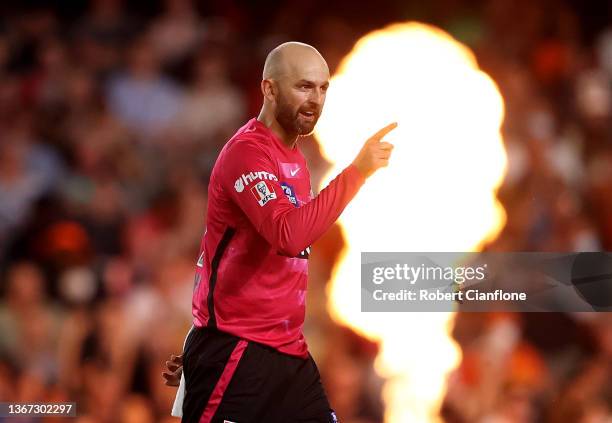 Nathan Lyon of the Sydney Sixers celebrates taking the wicket of Colin Munro of the Scorchers during the Men's Big Bash League match between the...