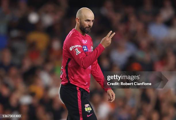 Nathan Lyon of the Sydney Sixers celebrates taking the wicket of Colin Munro of the Scorchers during the Men's Big Bash League match between the...