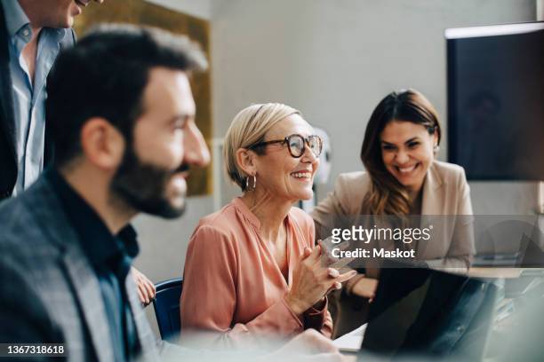 happy business people discussing during meeting in board room at corporate office - office employee imagens e fotografias de stock