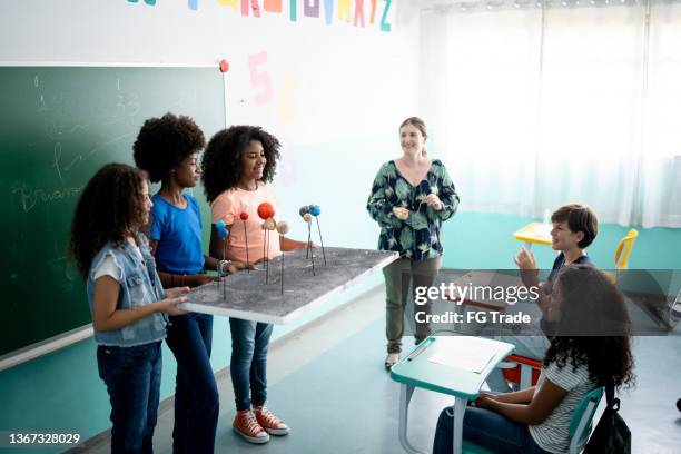 girls doing a presentation about the solar system in the classroom - kid presenting stock pictures, royalty-free photos & images