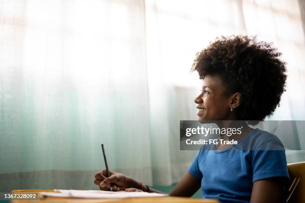 contemplative girl in the classroom - gratitude journal stock pictures, royalty-free photos & images