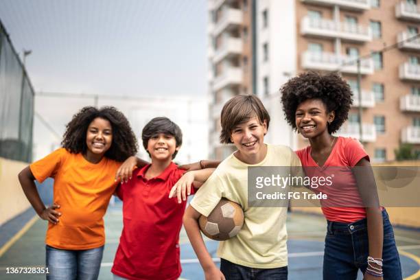 portrait of kids with a ball at a sports court - brazil and outside and ball stock pictures, royalty-free photos & images