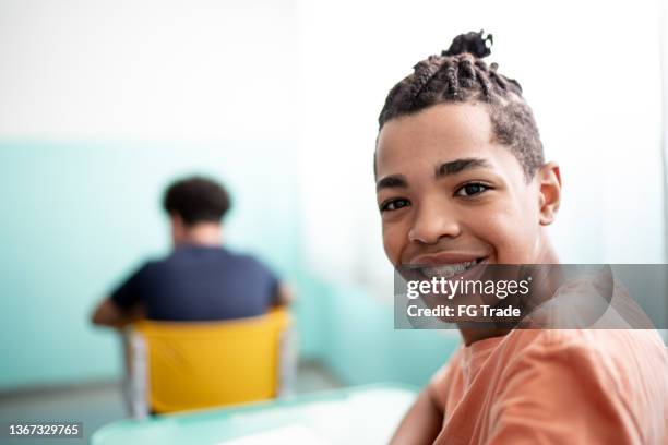 portrait of a boy studying in the classroom - boys with braces stock pictures, royalty-free photos & images