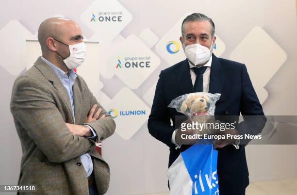 The commercial director of the ILUNION group, Oscar da Pena, presents a stuffed dog to the Minister of the Presidency, Justice and the Interior of...