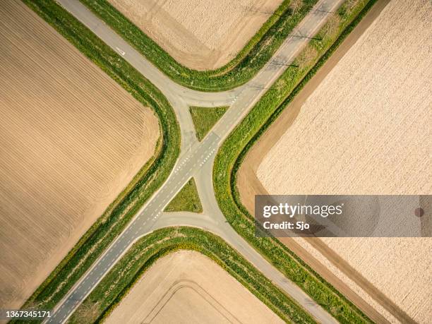 crossroads in a rural landscape seen from above - flower bed stock pictures, royalty-free photos & images