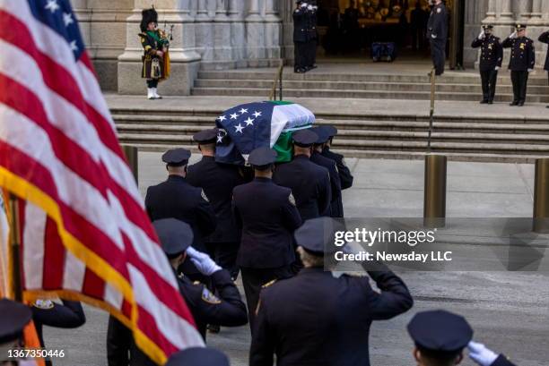 Police officers salute coffin of fallen NYPD officer Jason Rivera outside St. Patrick's Cathedral in Manhattan, during wake services on January 27,...