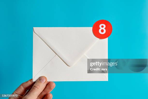 hand holding white envelope with notification-email concept - inbox ストックフォトと画像